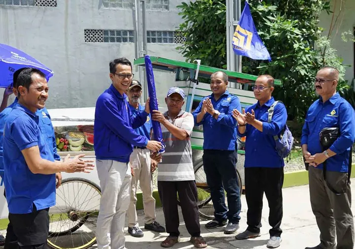 Ade Wardhana Adinata menyerahkan payung usaha kepada pelaku UMKM bersama jajaran Partai Gema Bangsa dalam kegiatan pelayanan masyarakat di Jawa Barat